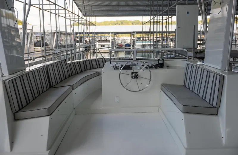 Slide: The Image of 2007 Sharpe 20 x 100 boat interior with striped seating and steering wheel. - 39