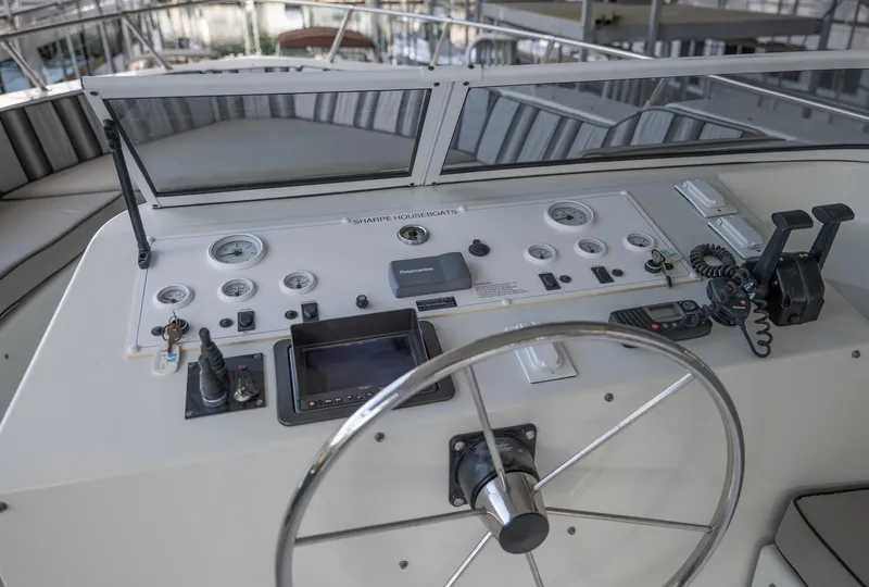 Slide: The Image of Control panel of a 2007 Sharpe 20 x 100 boat with steering wheel and gauges. - 40