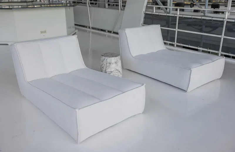 Slide: The Image of Modern white lounge chairs with a small marble side table in a minimalist setting. - 47