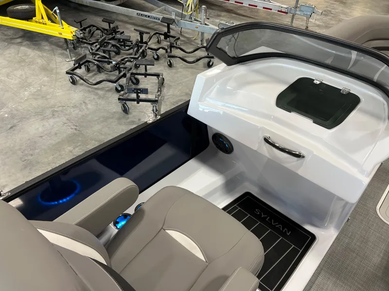 Slide: The Image of The image shows the cockpit of a 2024 Sylvan S-5 LZ DC boat with gray seats. - 10