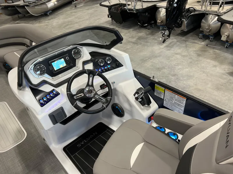 Slide: The Image of The image shows the cockpit of a 2024 Sylvan S-5 LZ DC boat with modern instruments. - 11