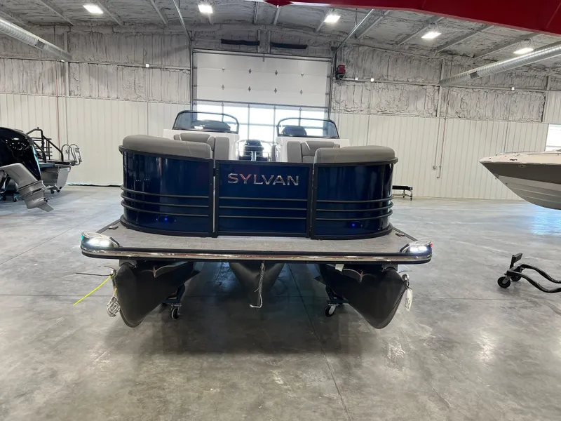 Slide: The Image of A 2024 Sylvan S-5 LZ DC pontoon boat is in a warehouse. It features a blue hull. - 4