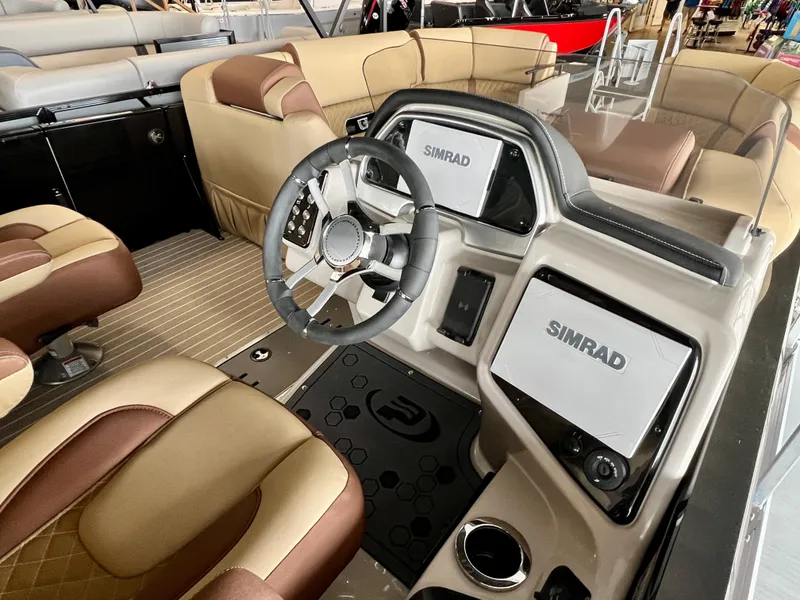 Slide: The Image of 2024 Princecraft Vogue 25 XT boat interior with steering wheel and Simrad displays. - 4