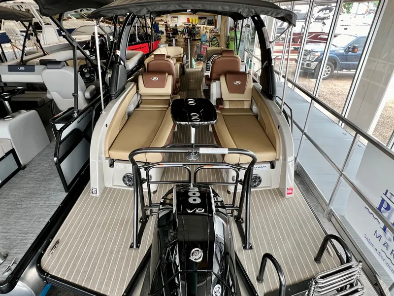 Slide: The Image of 2024 Princecraft Vogue 25 XT pontoon boat interior with seating and outboard motor. - 5