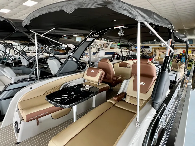 Slide: The Image of 2024 Princecraft Vogue 25 XT pontoon boat with luxurious seating and black canopy. - 6