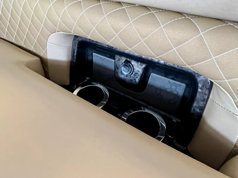 Slide: The Image of Princecraft Vogue 25 XT 2024 boat interior with cup holders and beige quilted upholstery. - 7