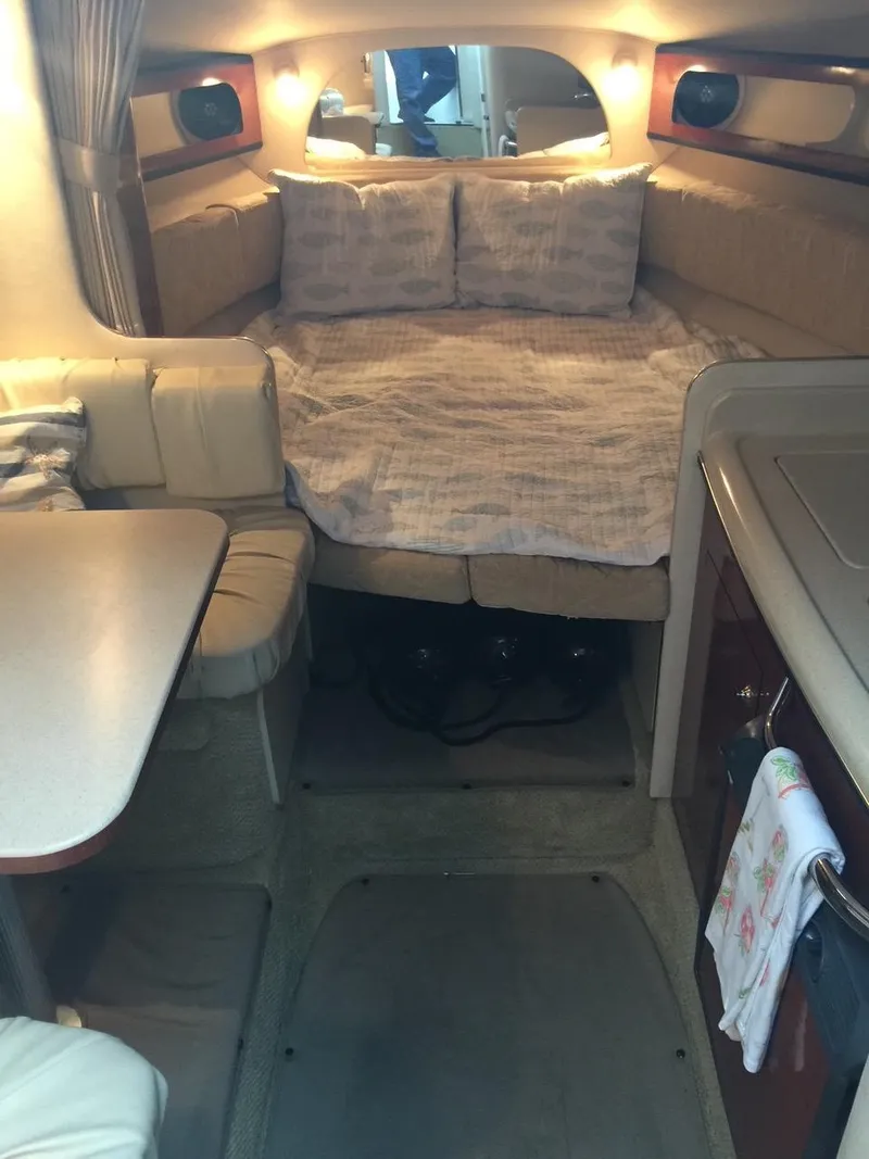 Slide: The Image of Interior cabin of a 2004 Sea Ray 280 Sundancer with bed and seating area. - 14