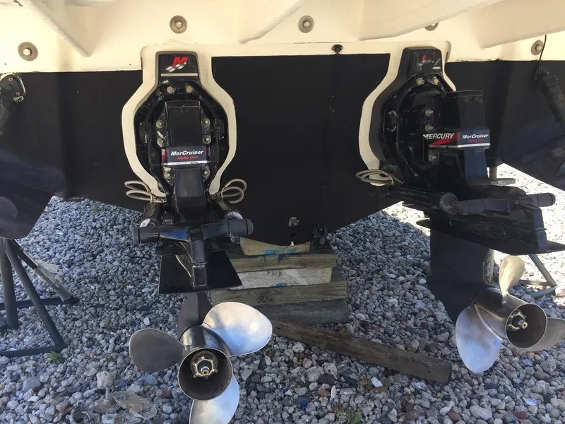 Slide: The Image of 2004 Sea Ray 280 Sundancer with twin MerCruiser engines on gravel. - 17