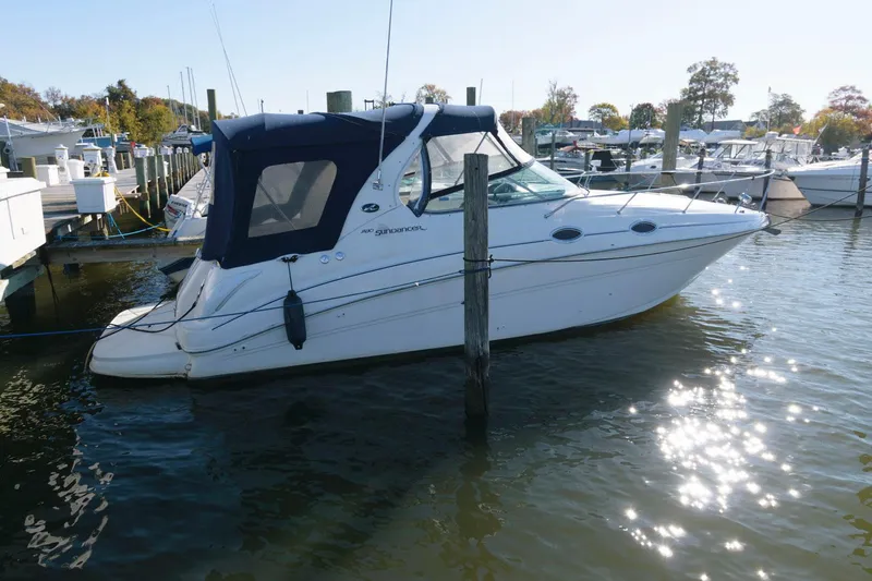Slide: The Image of 2004 Sea Ray 280 Sundancer docked at a marina. - 2