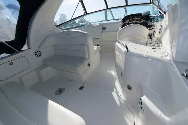 Slide: The Image of Interior of 2004 Sea Ray 280 Sundancer boat with white seating and helm. - 8