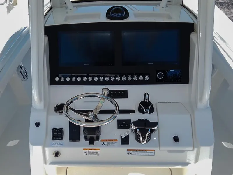 Slide: The Image of 2024 Regulator 28 boat dashboard with dual screens and controls. - 11