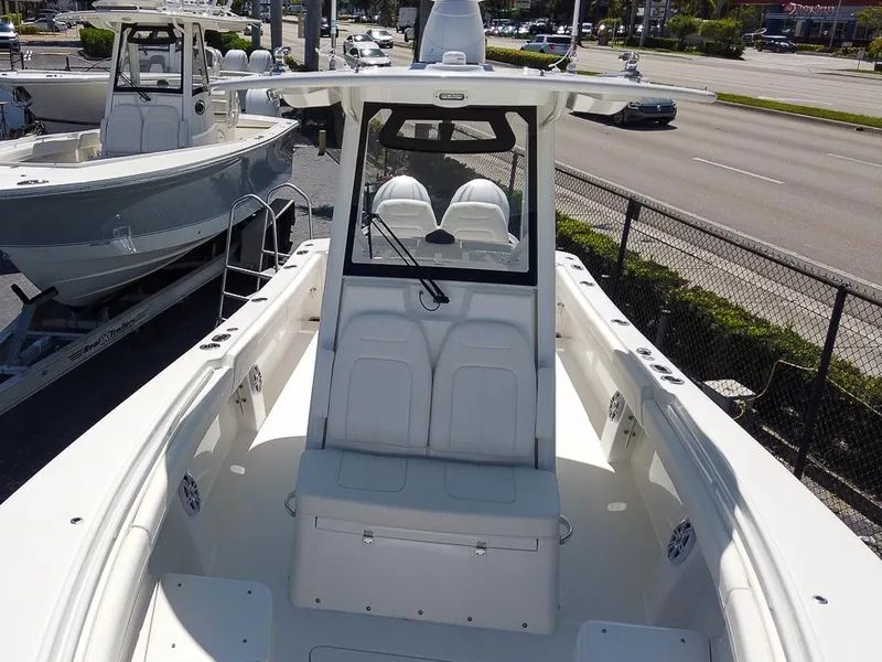 Slide: The Image of 2024 Regulator 28 boat, front view, docked near a road. - 13