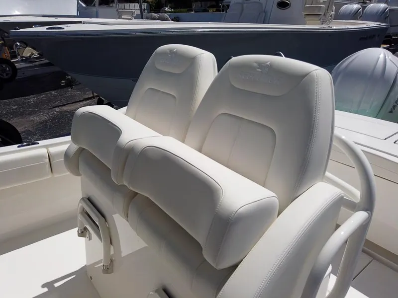 Slide: The Image of 2024 Regulator 28 boat with dual white cushioned seats. - 17