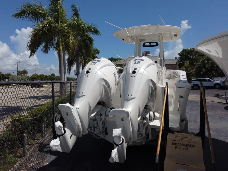 Slide: The Image of 2024 Regulator 28 boat with twin outboard engines in a marina. - 27