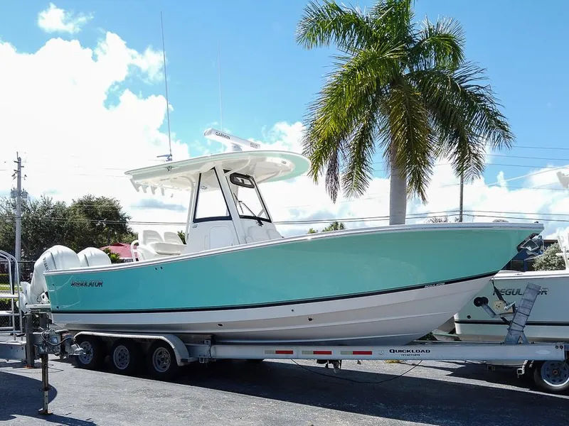 Slide: The Image of 2024 Regulator 28 boat on trailer, palm tree background. - 7