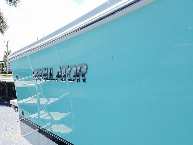 Slide: The Image of 2024 Regulator 28 boat side view with logo in bright blue color. - 9