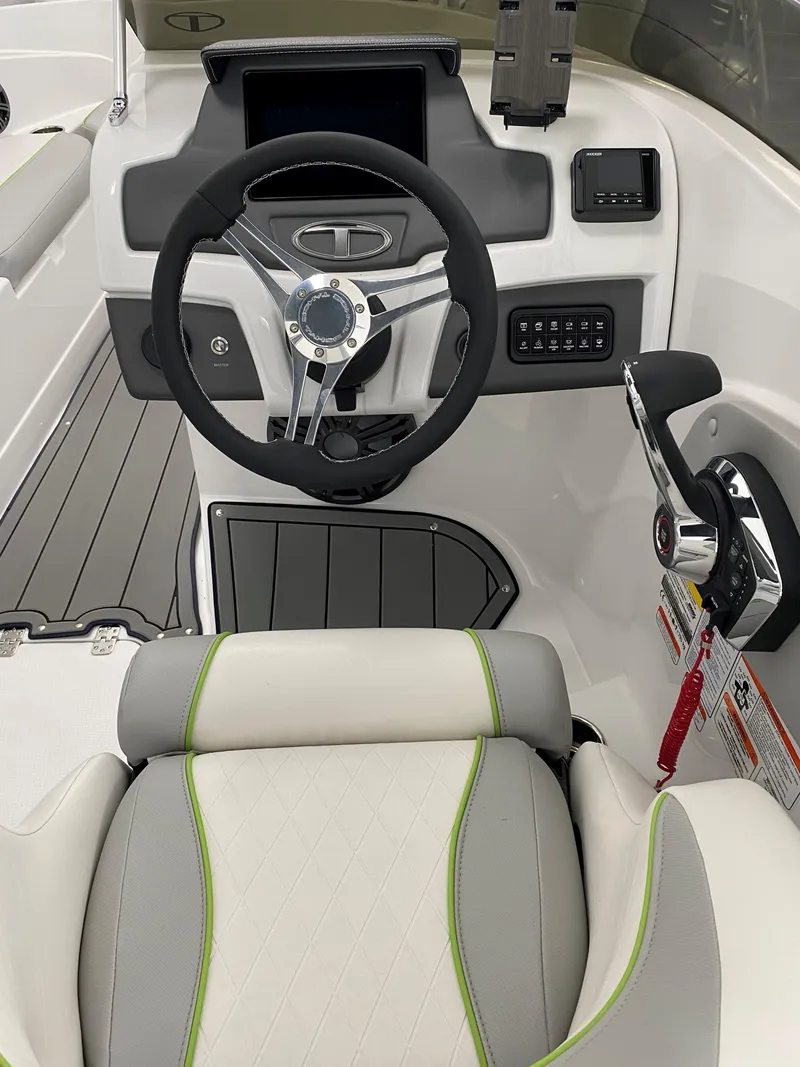 Slide: The Image of 2024 Tahoe 210 Si Limited boat cockpit with steering wheel and control panel. - 1