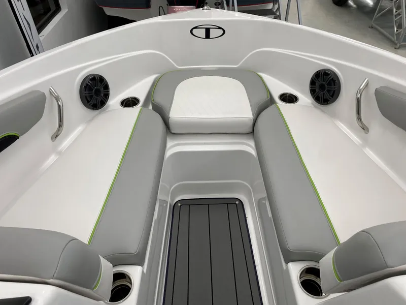 Slide: The Image of 2024 Tahoe 210 Si Limited boat interior with gray and white seating, cup holders, and speakers. - 3