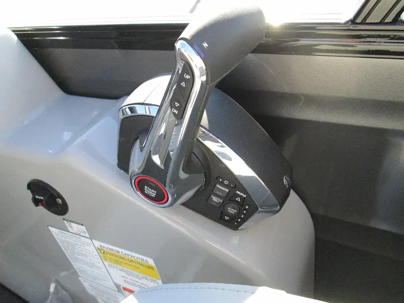 Slide: The Image of 2024 Regency 230 DL3 boat throttle control and dashboard. - 14