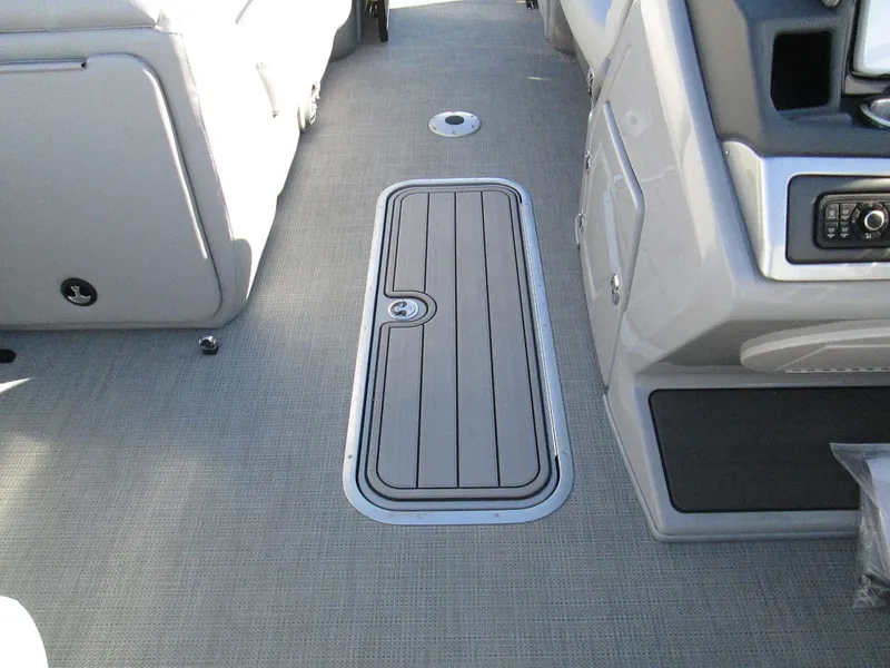 Slide: The Image of 2024 Regency 230 DL3 boat interior with storage compartment and control panel. - 15