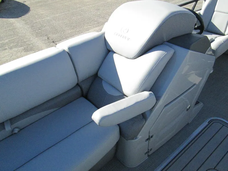 Slide: The Image of 2024 Regency 230 DL3 boat interior with plush seating and armrest. - 18