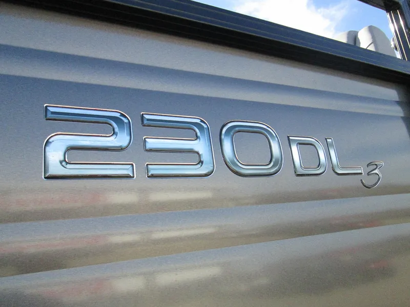 Slide: The Image of 2024 Regency 230 DL3 model emblem on metallic surface - 21