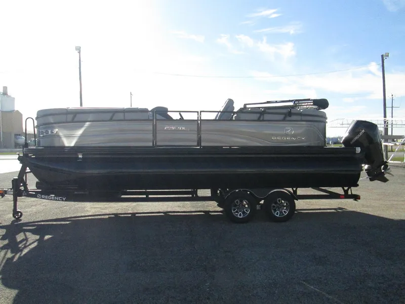 Slide: The Image of 2024 Regency 230 DL3 pontoon boat on a trailer in a parking lot. - 4