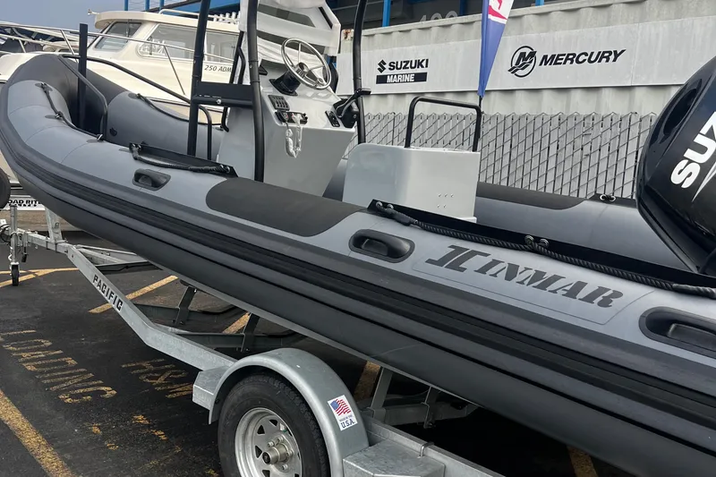 Slide: The Image of 2024 Inmar 670 Demo Boat on trailer, featuring Suzuki and Mercury marine engines. - 2