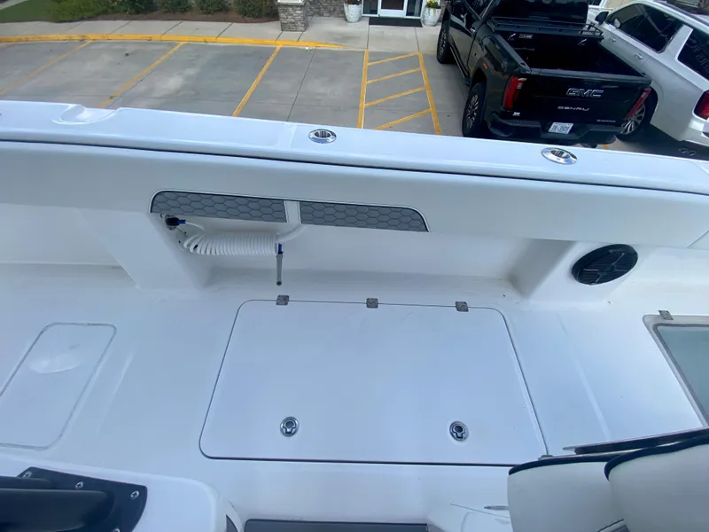 Slide: The Image of 2022 Invincible 35 Catamaran deck with storage compartments and hose. - 20