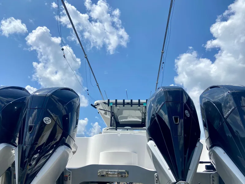 Slide: The Image of 2022 Invincible 35 Catamaran with powerful outboard engines under a clear blue sky. - 3