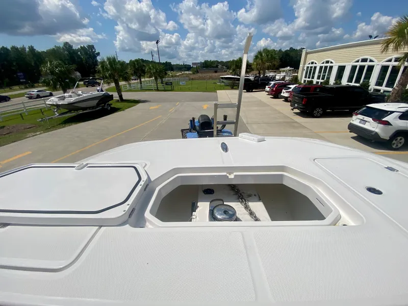 Slide: The Image of 2022 Invincible 35 Catamaran on display at a dealership under a sunny sky. - 35