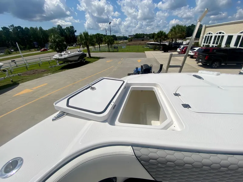 Slide: The Image of 2022 Invincible 35 Catamaran with open storage compartment, parked outdoors on a sunny day. - 38