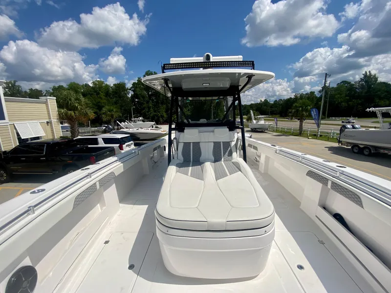 Slide: The Image of 2022 Invincible 35 Catamaran with spacious deck and modern seating under a sunny sky. - 39