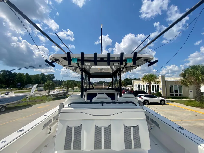 Slide: The Image of 2022 Invincible 35 Catamaran with spacious seating and modern design, docked under a sunny sky. - 40