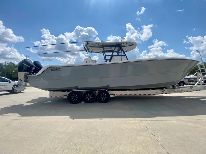 Slide: The Image of 2022 Invincible 35 Catamaran on a trailer under a sunny sky. - 1