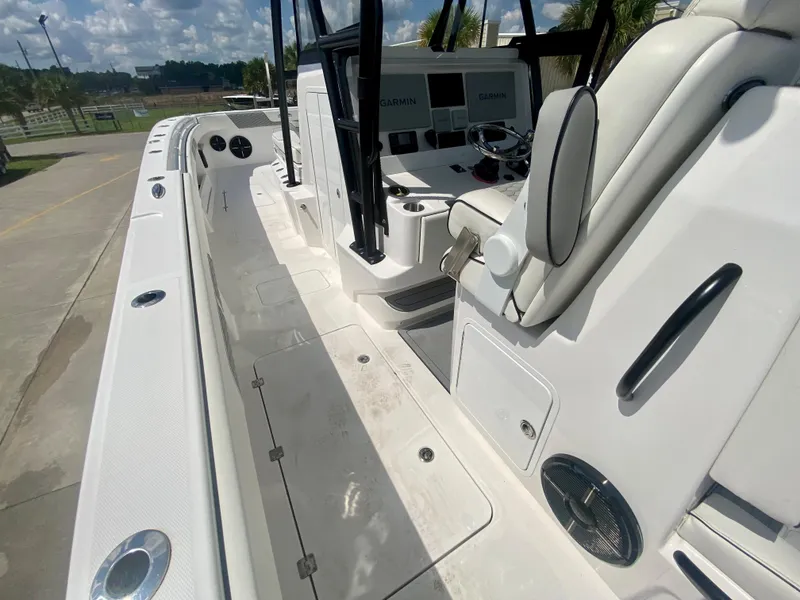 Slide: The Image of 2022 Invincible 35 Catamaran boat interior with white seating and Garmin navigation system. - 12