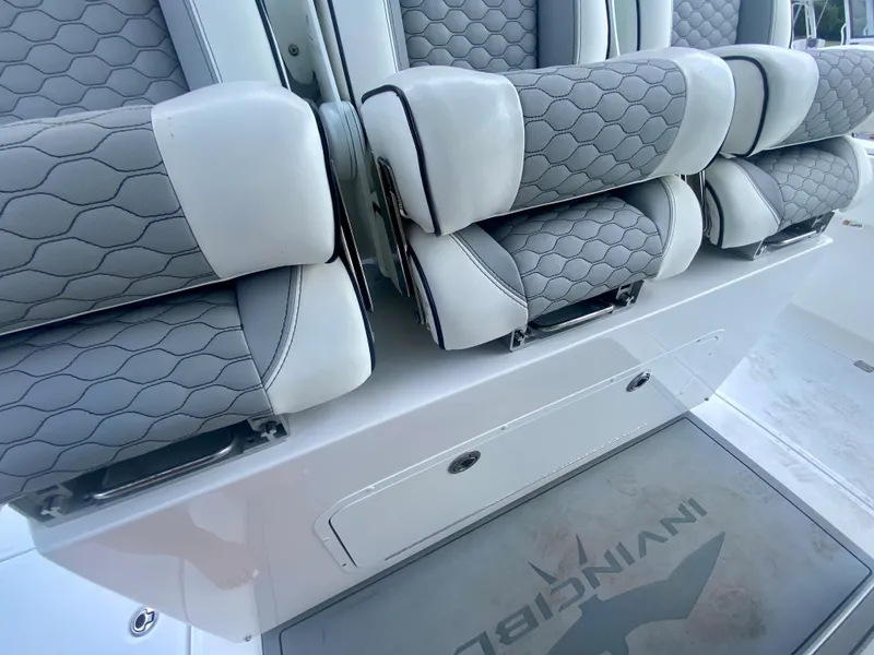 Slide: The Image of 2022 Invincible 35 Catamaran, close-up of luxurious seating with hexagonal pattern upholstery. - 16