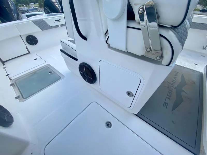 Slide: The Image of 2022 Invincible 35 Catamaran interior, featuring storage compartments and seating. - 21