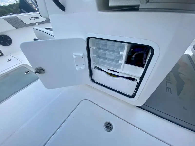 Slide: The Image of Open storage compartment on 2022 Invincible 35 Catamaran boat. - 22