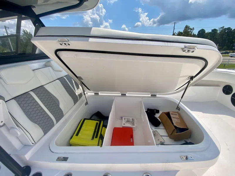 Slide: The Image of Open storage compartment on 2022 Invincible 35 Catamaran with various items inside. - 32