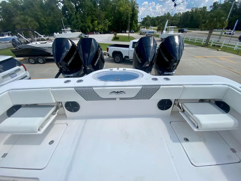 Slide: The Image of 2022 Invincible 35 Catamaran with quad Mercury outboard engines at a marina. - 7