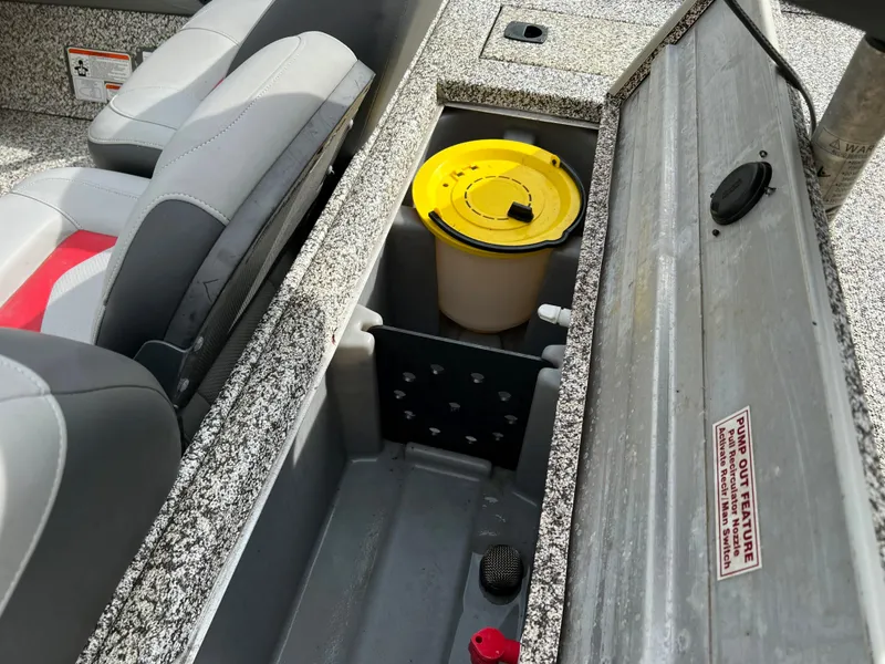 Slide: The Image of 2015 Tracker Pro Team 175 TXW boat interior storage compartment with yellow lid container. - 17