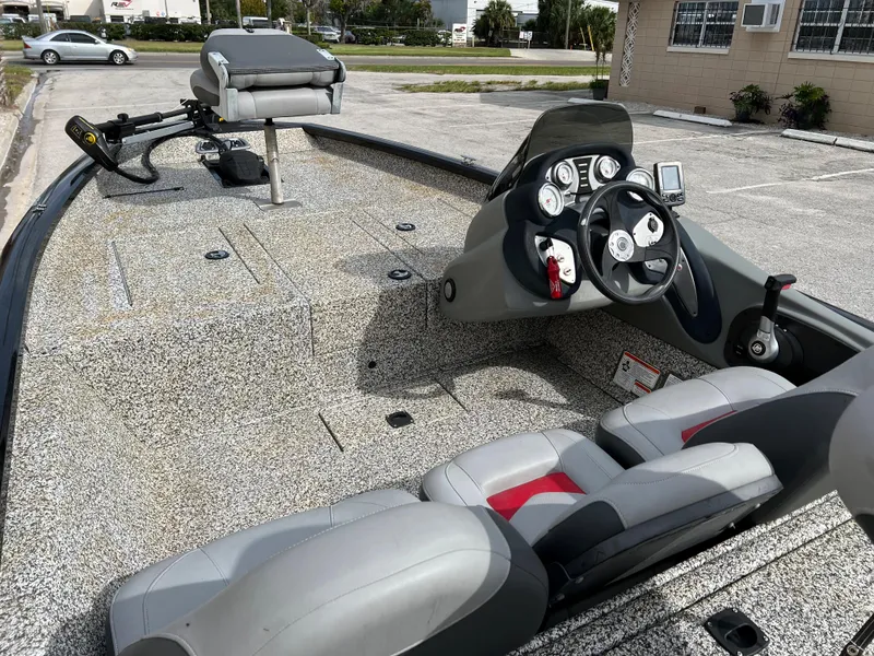 Slide: The Image of 2015 Tracker Pro Team 175 TXW fishing boat interior with steering console and seating. - 18