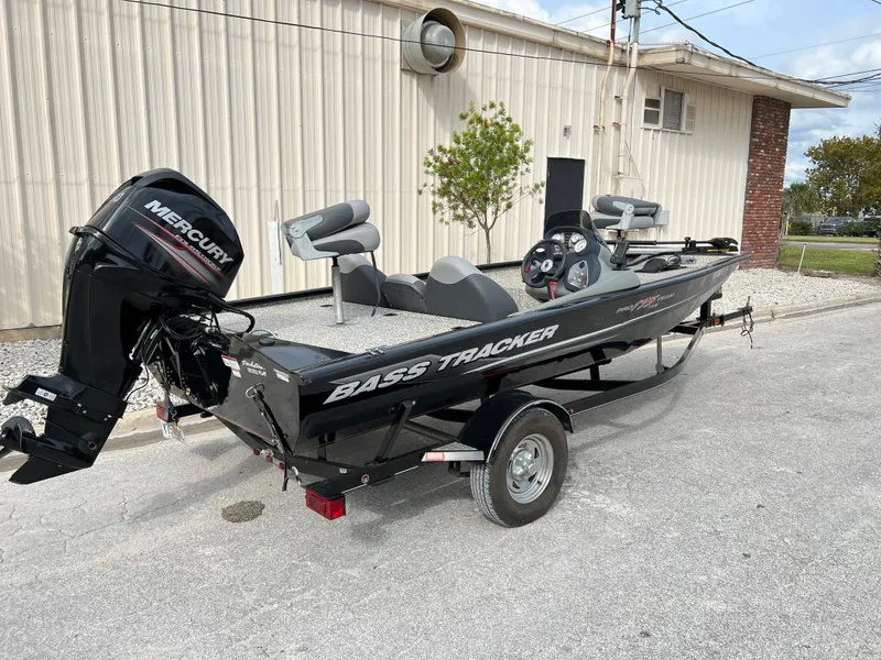 Slide: The Image of 2015 Tracker Pro Team 175 TXW bass boat with Mercury outboard motor. - 2