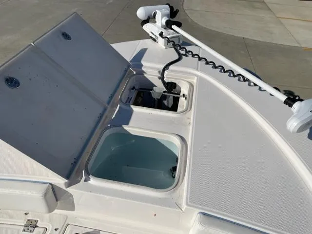 Slide: The Image of 2022 Robalo 246 Cayman boat with open storage compartments and trolling motor. - 12