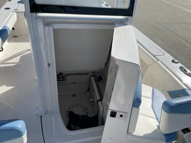 Slide: The Image of 2022 Robalo 246 Cayman boat interior storage compartment with open door. - 13