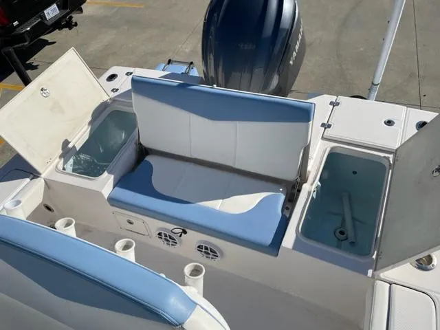 Slide: The Image of 2022 Robalo 246 Cayman boat with blue and white seating and storage compartments. - 6