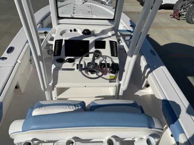 Slide: The Image of 2022 Robalo 246 Cayman boat cockpit with steering wheel and control panel. - 7