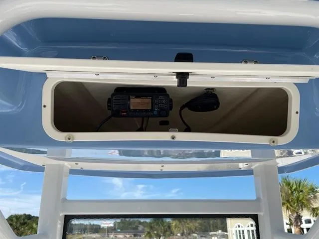 Slide: The Image of 2022 Robalo 246 Cayman boat console with mounted radio and microphone. - 9