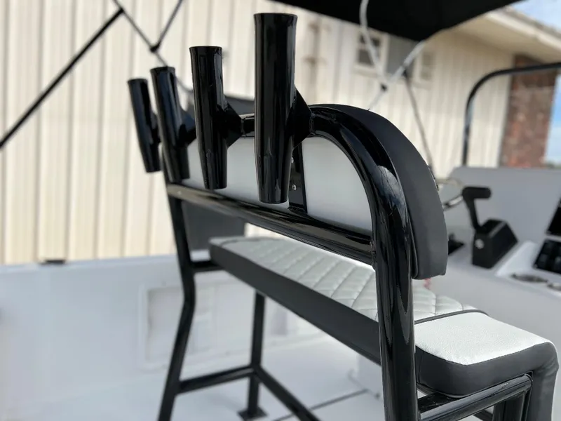 Slide: The Image of 2024 Clearwater 1900 boat with rod holders and cushioned seating. - 13